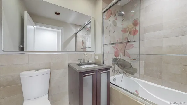 a bathroom with a granite countertop sink a toilet and a bathtub