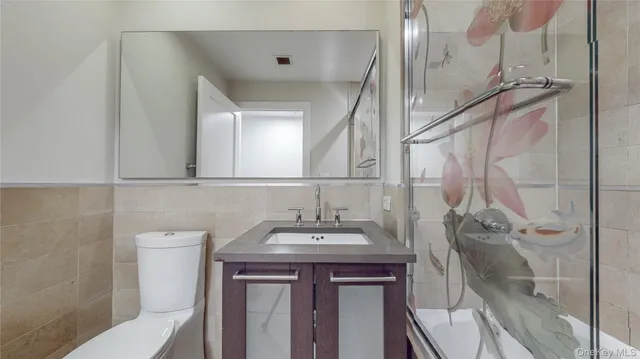 a bathroom with a sink a toilet and mirror