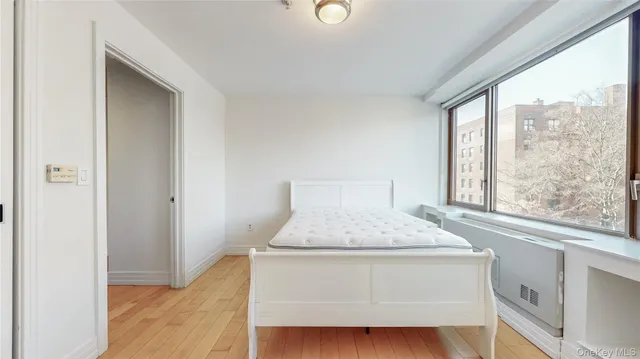 a bedroom with a bed and window