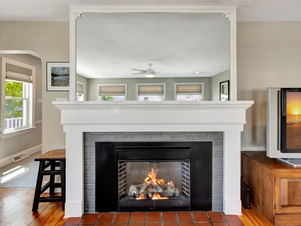 26 C Street Hull, MA 02045 - Photo 15 of 42 a living room with a fireplace and a window