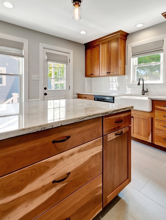 26 C Street Hull, MA 02045 - Photo 22 of 42 a kitchen with granite countertop cabinets stainless steel appliances a sink and a window