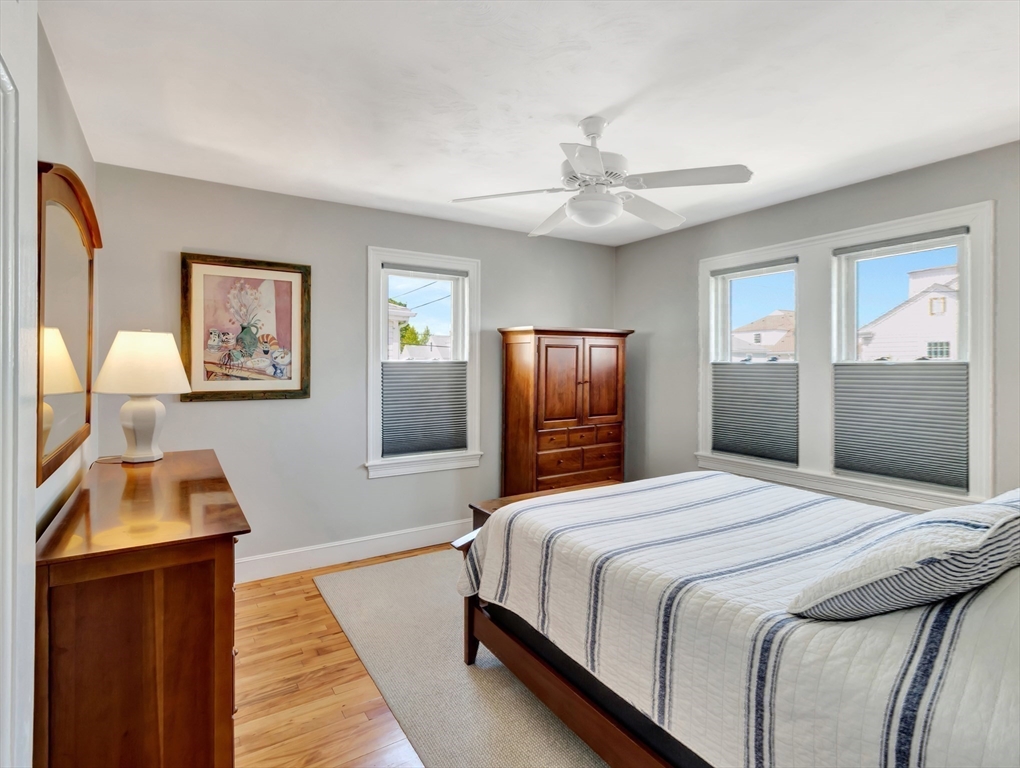 26 C Street Hull, MA 02045 - Photo 24 of 42 a bedroom with bed and wooden floor