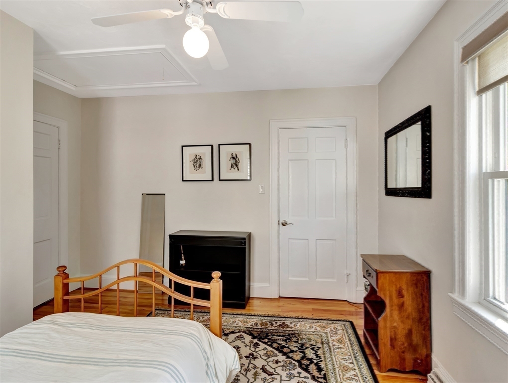 26 C Street Hull, MA 02045 - Photo 30 of 42 a bedroom with a bed and a fireplace