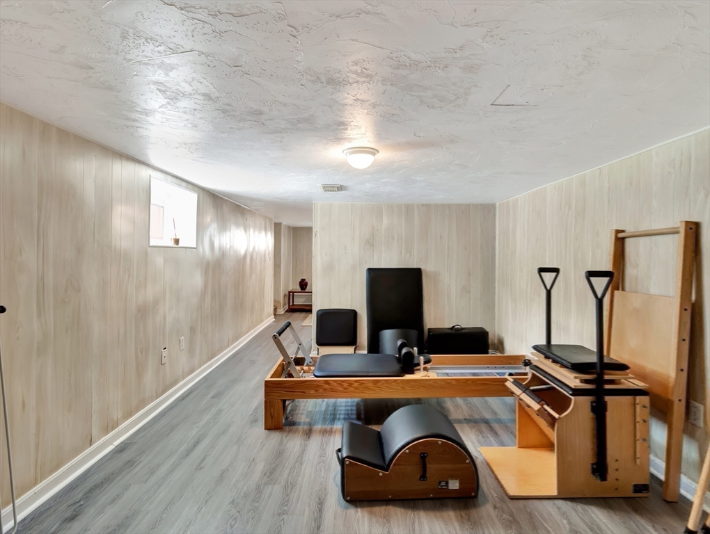 26 C Street Hull, MA 02045 - Photo 33 of 42 a room with gym equipment and a wooden floor