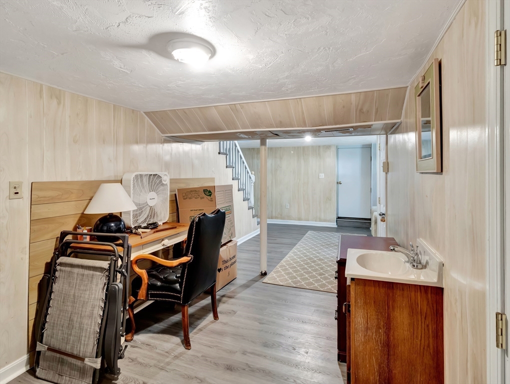 26 C Street Hull, MA 02045 - Photo 36 of 42 a bedroom with furniture and a gym equipment