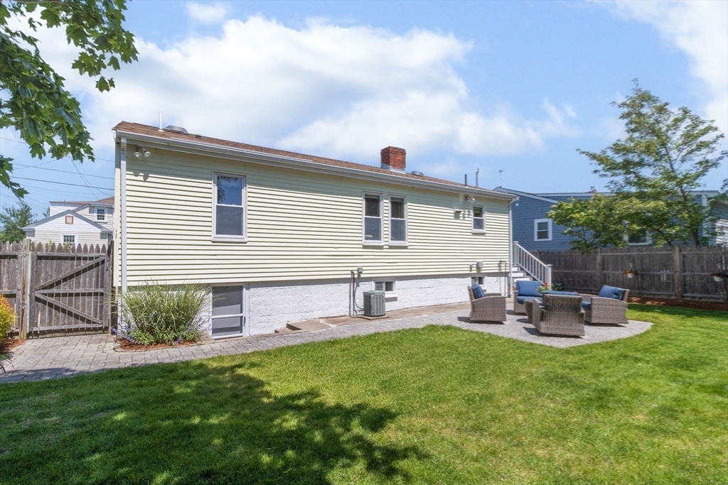 26 C Street Hull, MA 02045 - Photo 37 of 42 a front view of house with a garden and patio