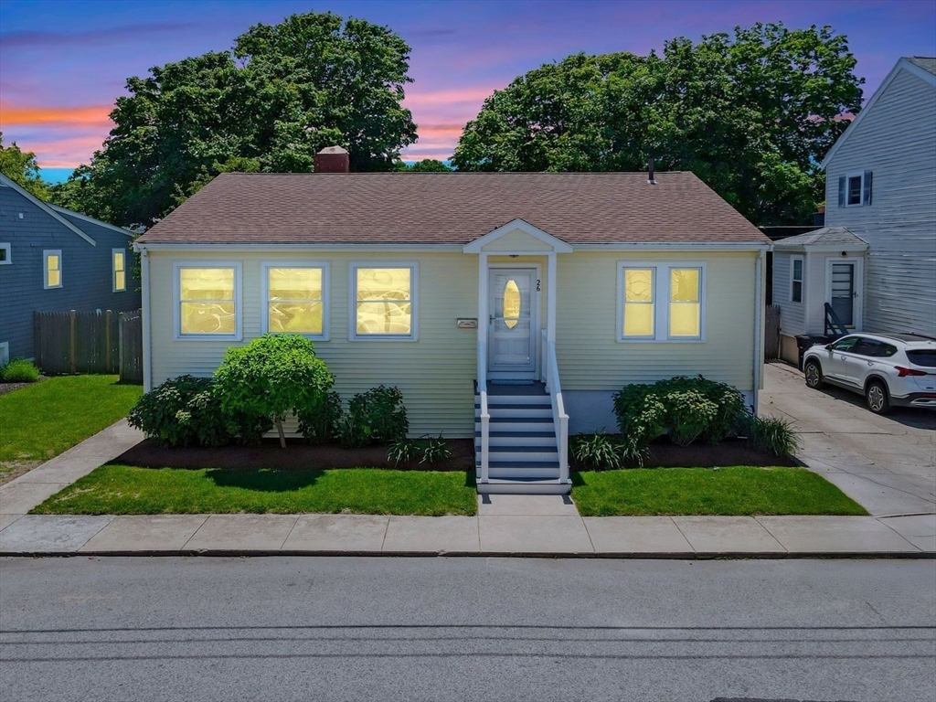 26 C Street Hull, MA 02045 - Photo 4 of 42 a front view of a house with a yard and garage