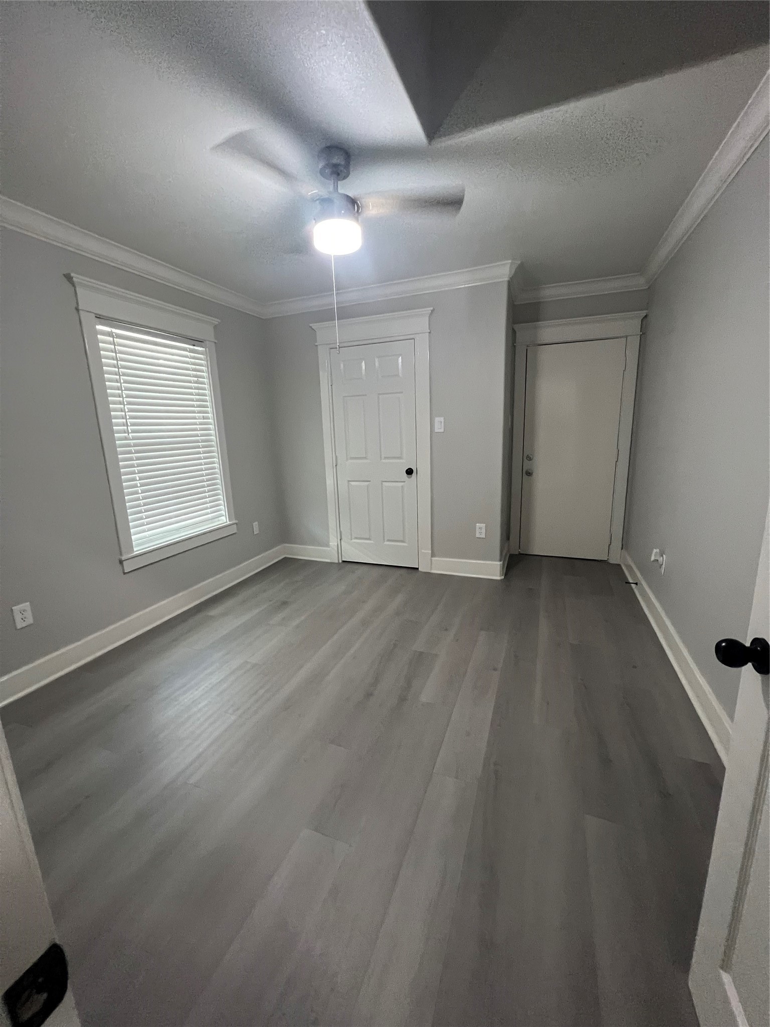 220 Redan Street, Unit A Houston, TX 77009 - Photo 16 of 22 an empty room with wooden floor and windows