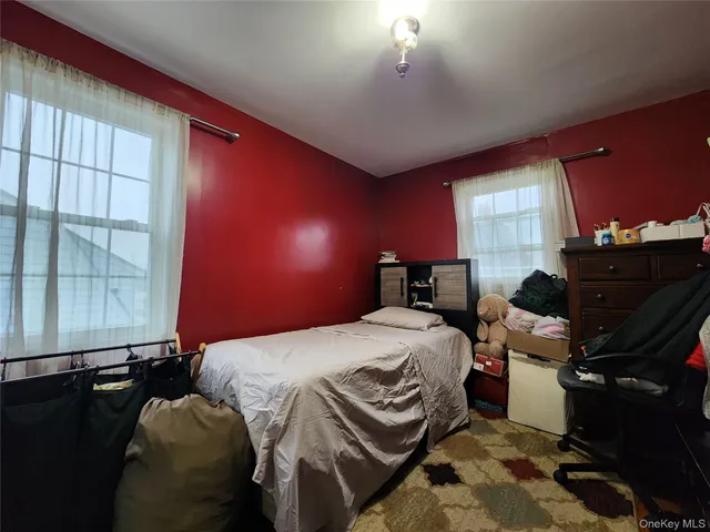 a bedroom with a bed and window