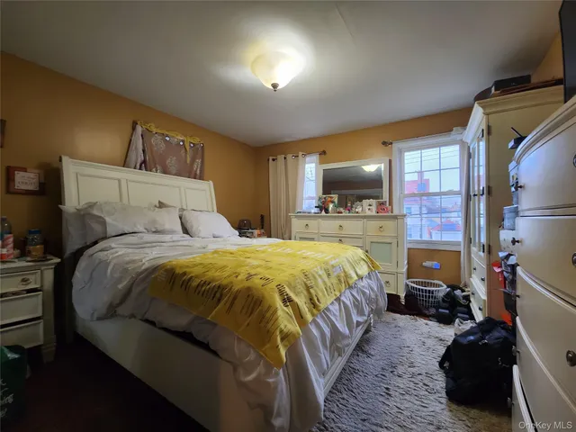 a bedroom with a bed and a mirror