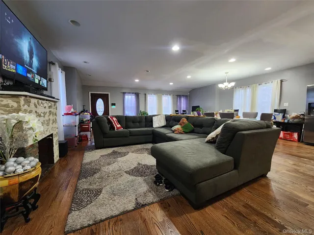 a living room with furniture kitchen view and a fireplace