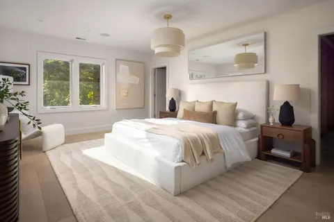 a bedroom with a large bed and a window