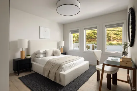 a bedroom with a bed a table and a chandelier