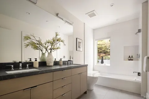 a bathroom with a double vanity sink and a bathtub