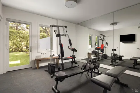 a view of a livingroom with workspace and a window