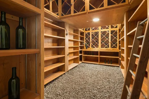 a view of an empty room with wooden floor and a cabinet