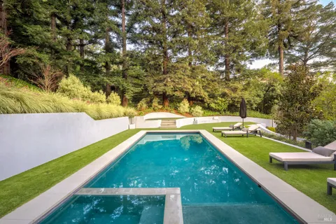 a view of a house with swimming pool and yard