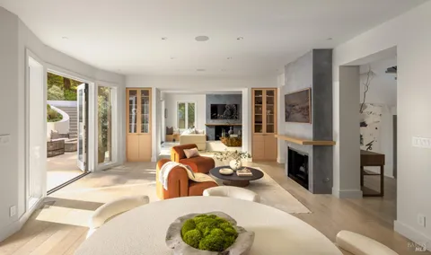 a living room with furniture large window and a fireplace