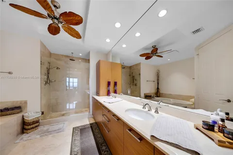 a bathroom with a tub shower and mirror