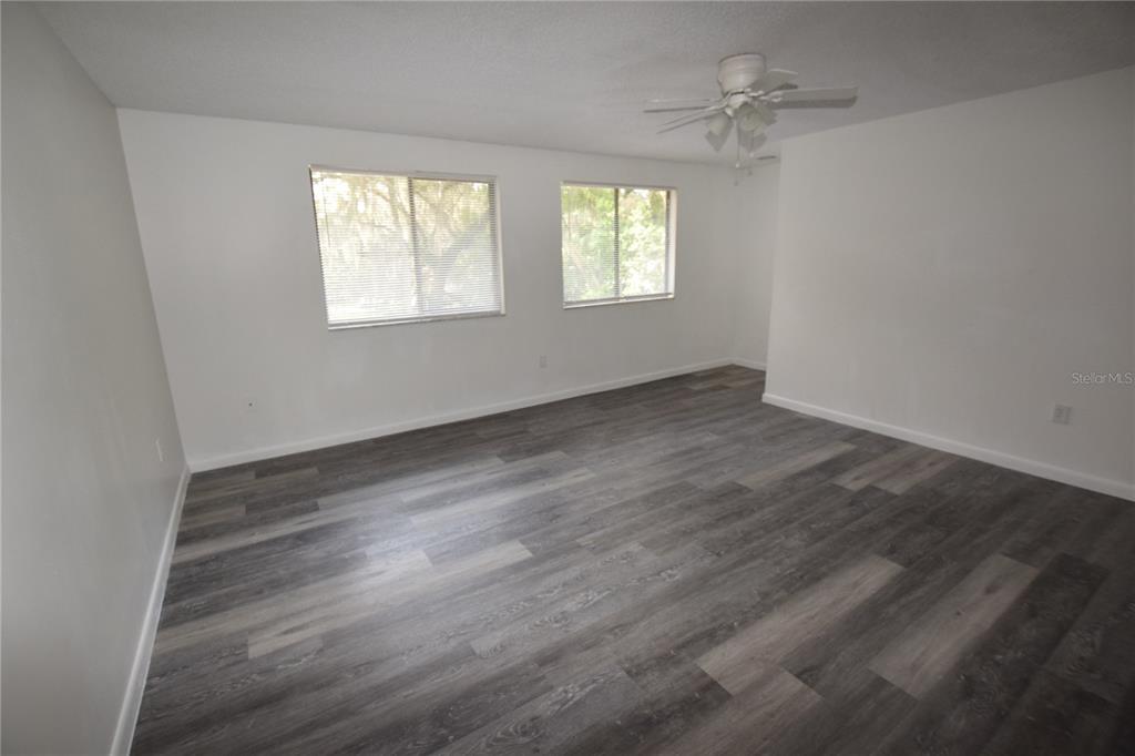 904 Sumter Street Leesburg, FL 34748 - Photo 21 of 27 wooden floor in an empty room with a window