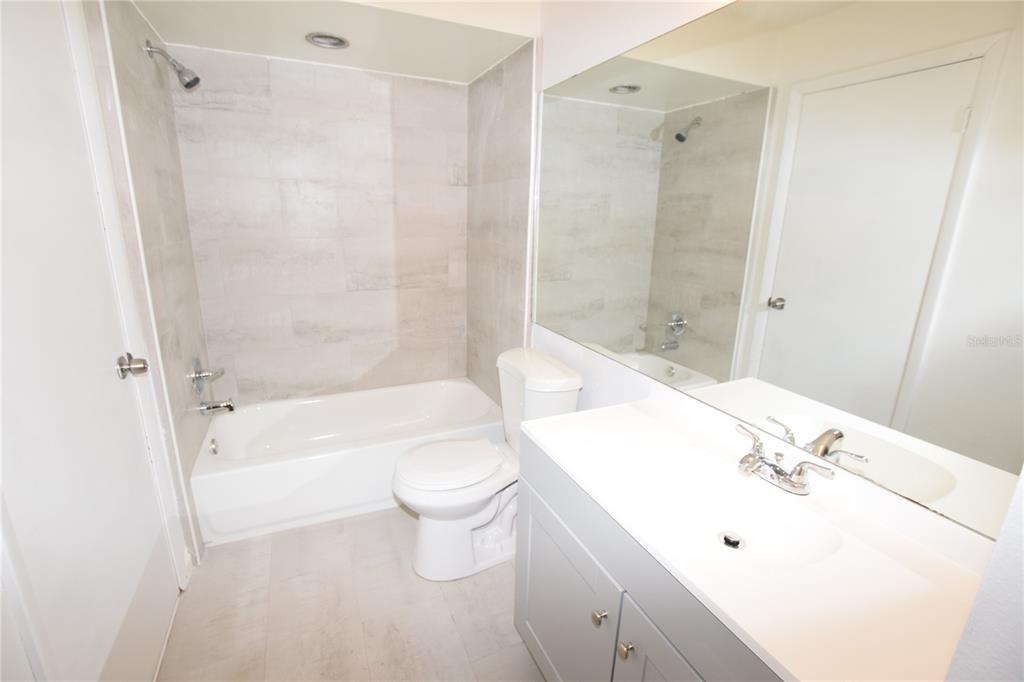 904 Sumter Street Leesburg, FL 34748 - Photo 4 of 27 a bathroom with a sink a toilet and shower