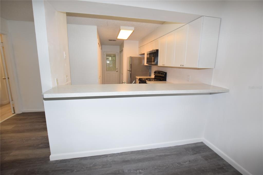 904 Sumter Street Leesburg, FL 34748 - Photo 10 of 27 a view of a living room with a wooden floor