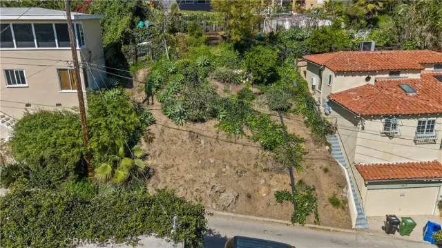 an aerial view of a house with yard and tree s