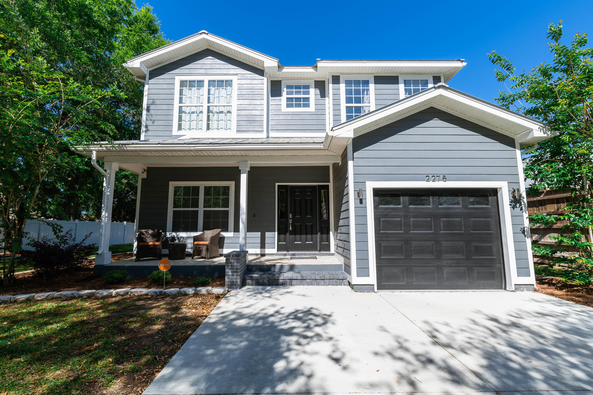 2275 Mack Bayou Road Santa Rosa Beach, FL 32459 - Photo 1 of 20 a front view of a house with a yard outdoor seating and garage