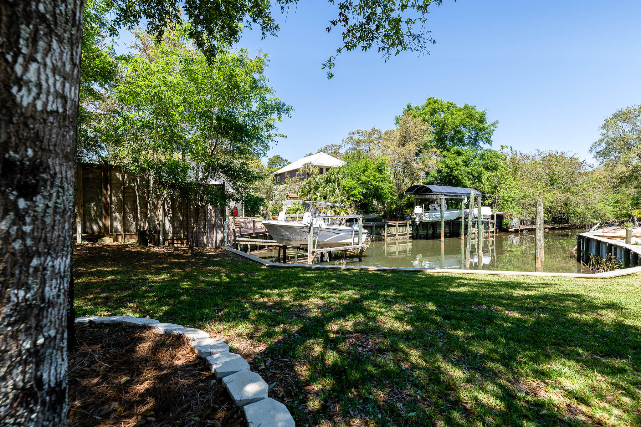 2275 Mack Bayou Road Santa Rosa Beach, FL 32459 - Photo 2 of 20 a view of a house with a yard porch and sitting area