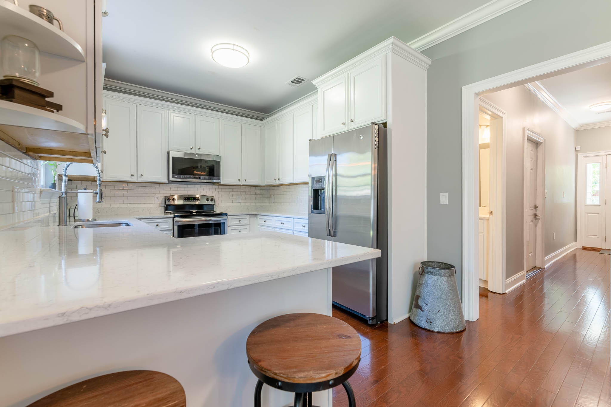 2275 Mack Bayou Road Santa Rosa Beach, FL 32459 - Photo 4 of 20 a kitchen with stainless steel appliances a refrigerator a sink a stove a microwave a center island and chairs