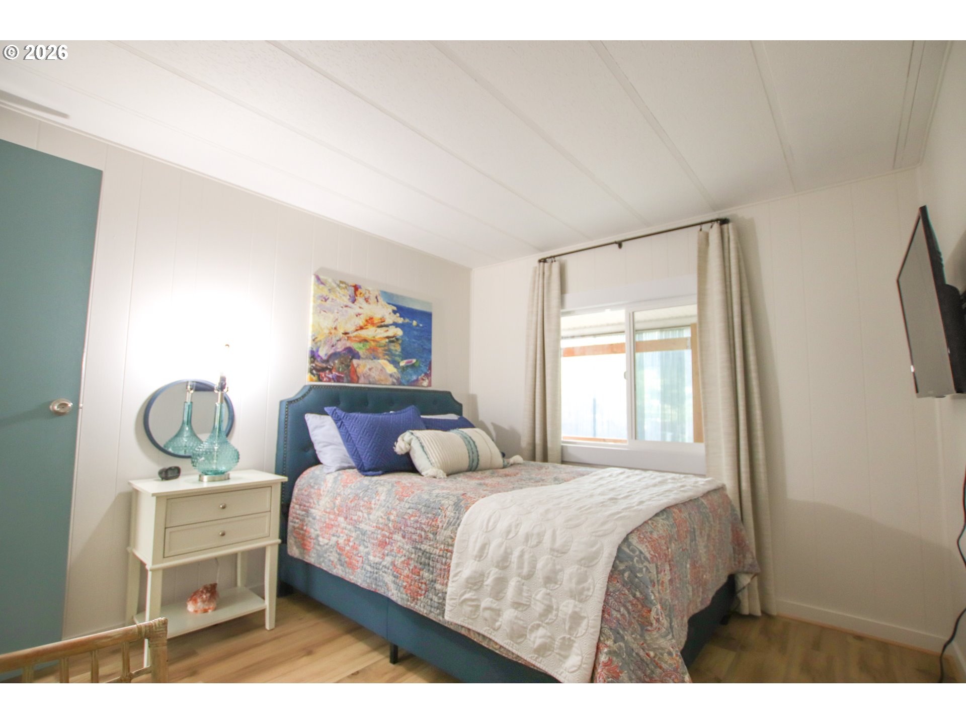 1431 Maple Street Florence, OR 97439 - Photo 18 of 43 a bedroom with a bed and window