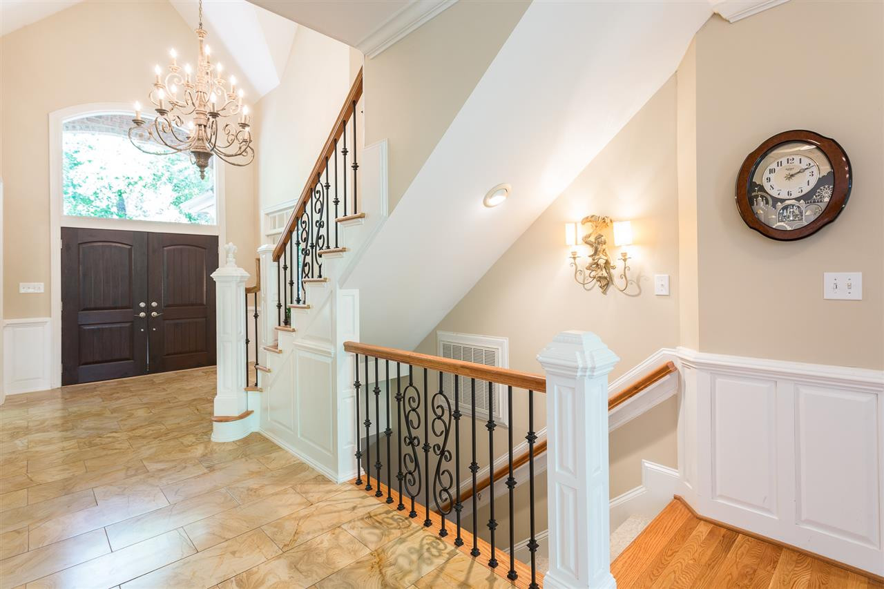 1001 Clingmans Place Raleigh, NC 27614 - Photo 4 of 30 A gracious two- story foyer welcomes you to the home and features new marble floors and a staircase with wrought iron spindles and hardwood stair treads. The foyer is open to the dining room and the first-floor office. Well-Appointed Foyer
