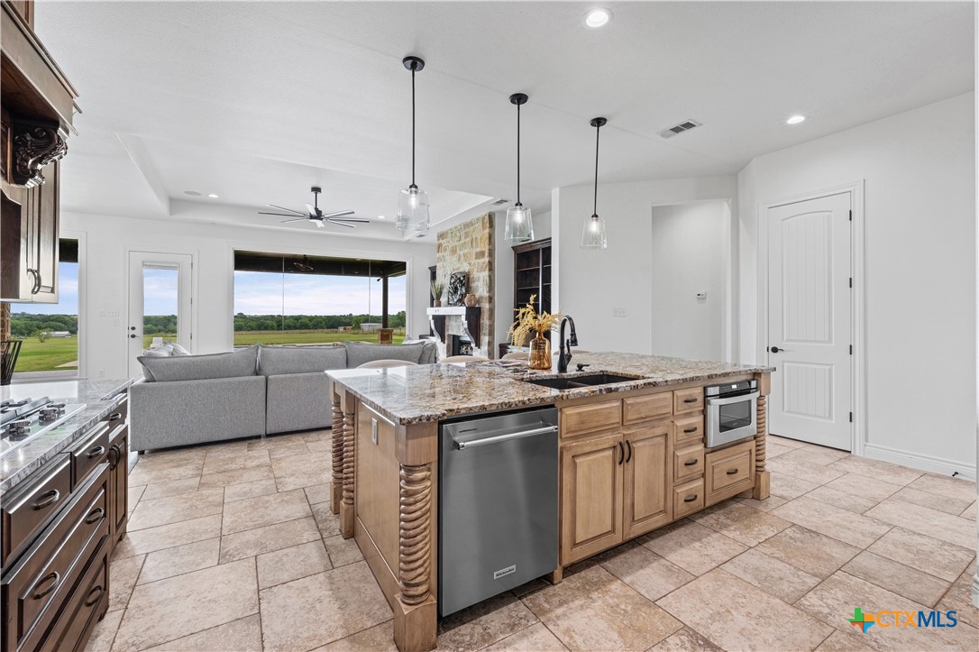 11023 Bigham Road Troy, TX 76579 - Photo 16 of 42 a kitchen with stainless steel appliances granite countertop a sink a stove and a wooden floors