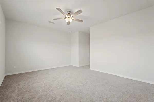 an empty room with a chandelier fan