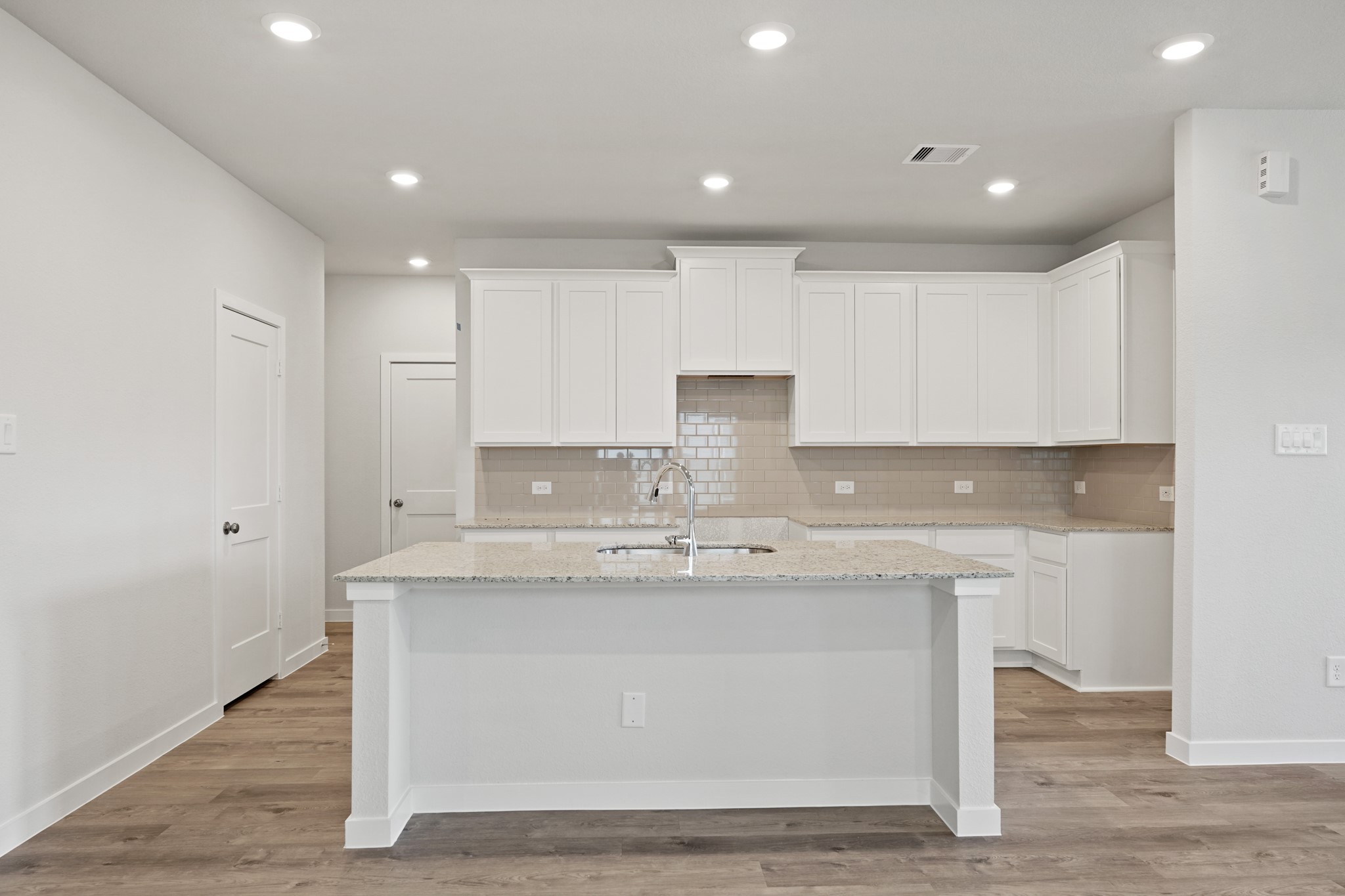 217 Spring Drive Hockley, TX 77447 - Photo 5 of 24 a kitchen with kitchen island stainless steel appliances a sink and cabinets