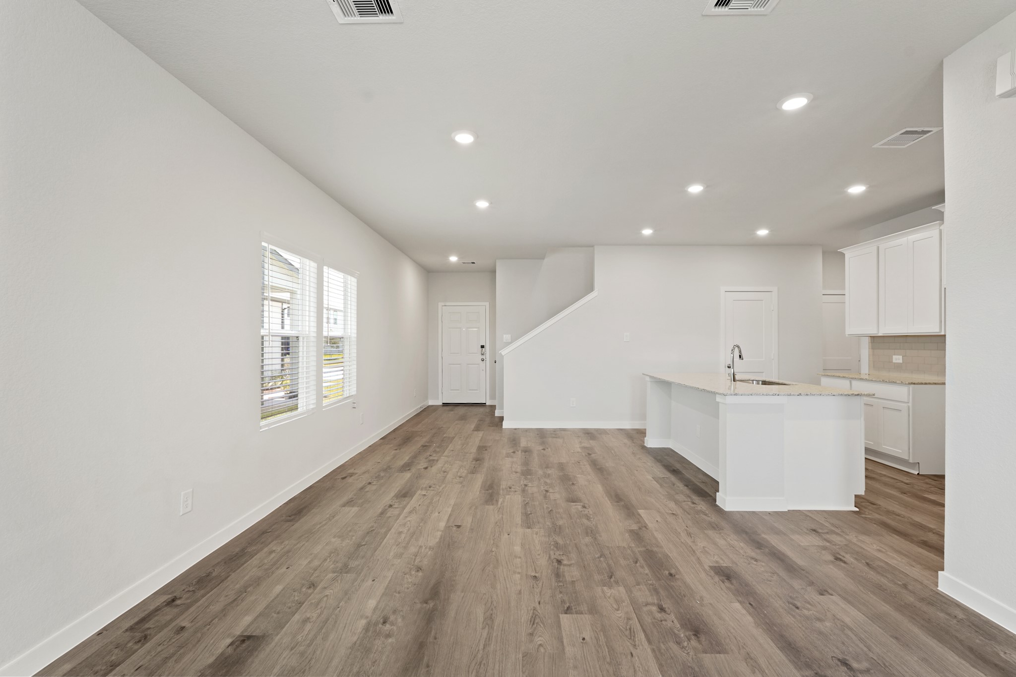 217 Spring Drive Hockley, TX 77447 - Photo 6 of 24 a view of an empty room with wooden floor and a window