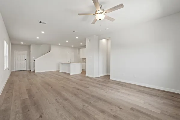 a view of an empty room with a ceiling fan