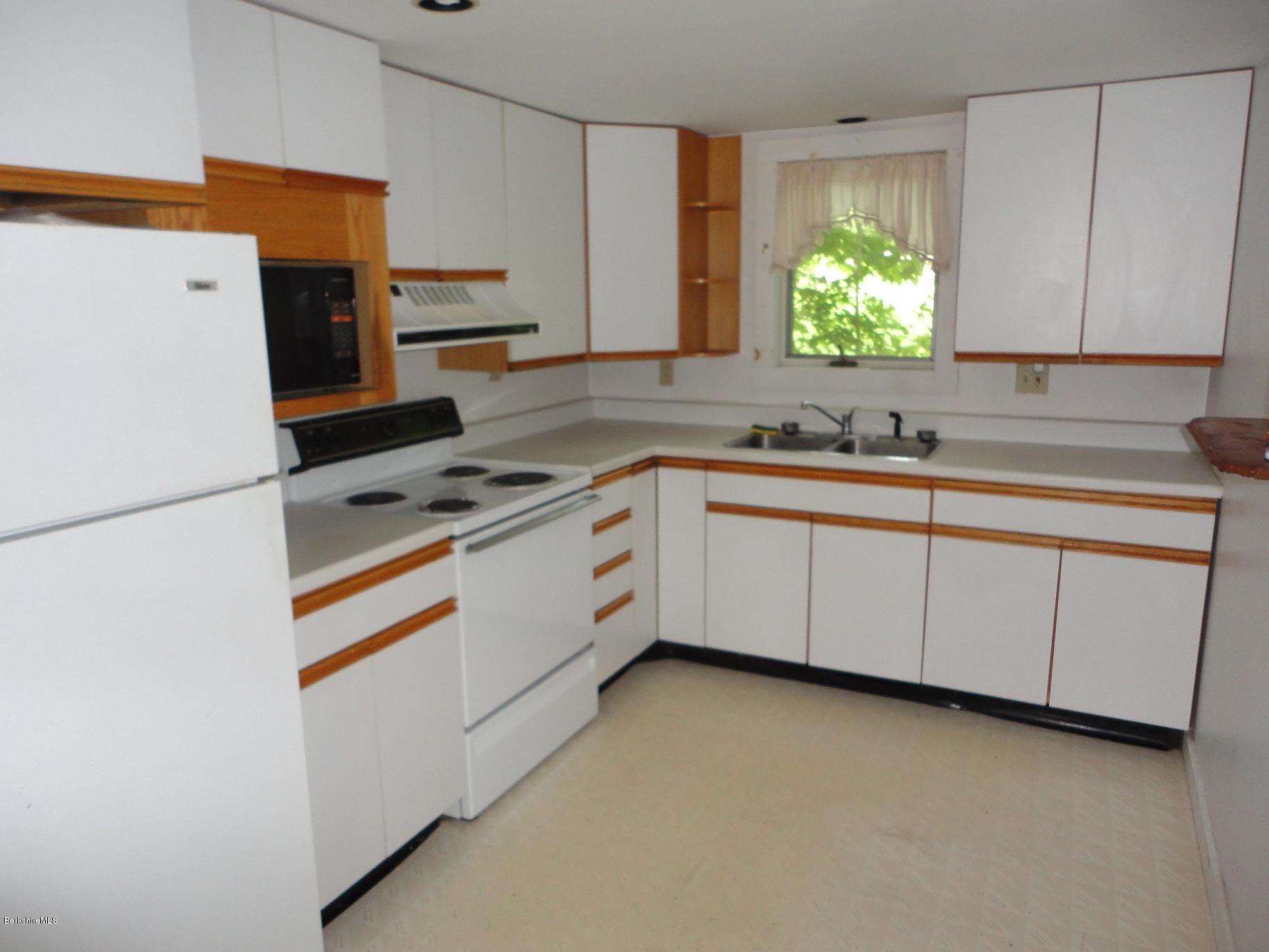 19 Swamp Road West Stockbridge, MA 01266 - Photo 9 of 12 a kitchen with stainless steel appliances a stove a sink and a refrigerator