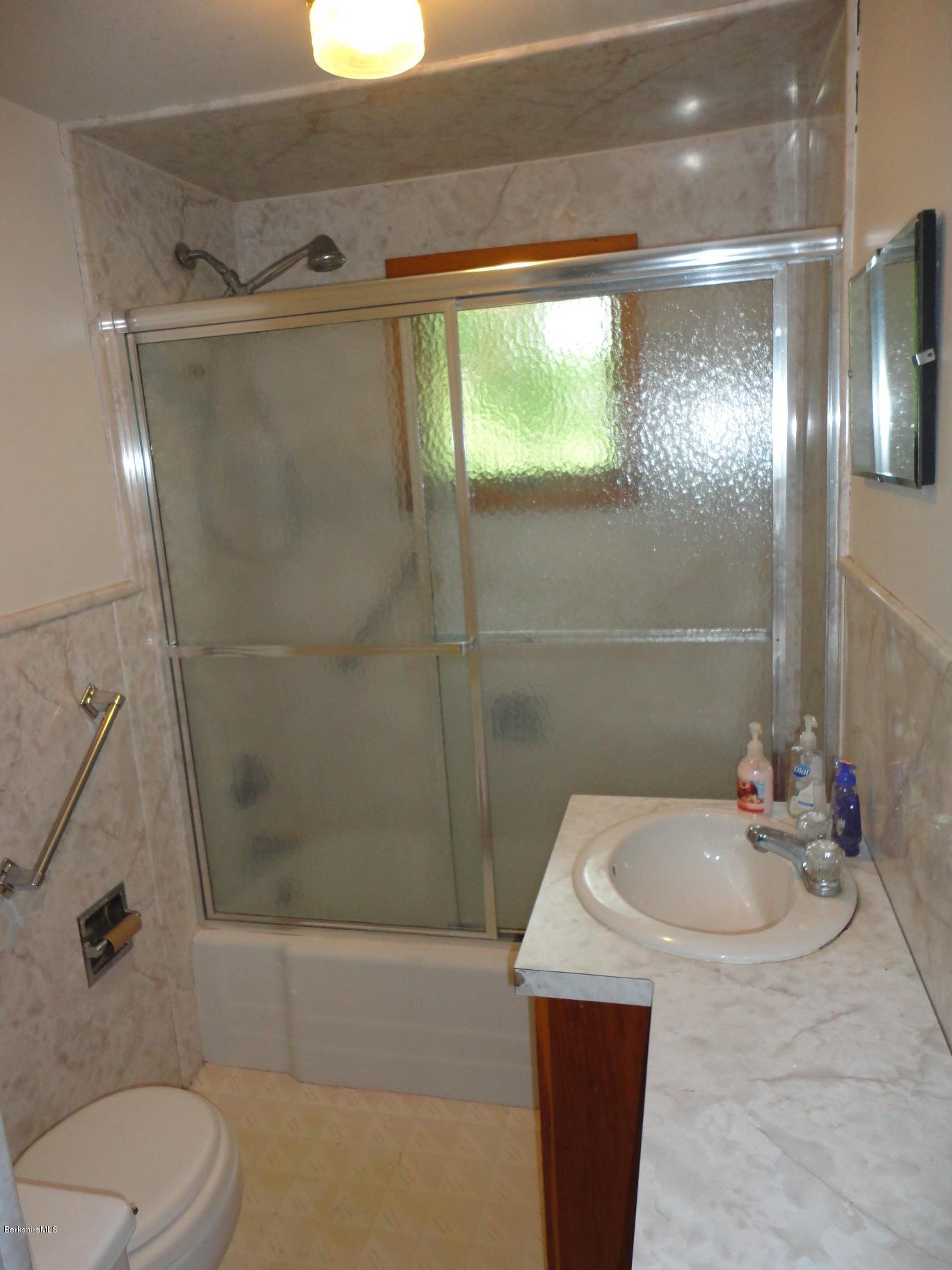 19 Swamp Road West Stockbridge, MA 01266 - Photo 10 of 12 a bathroom with a sink and mirror with bathtub