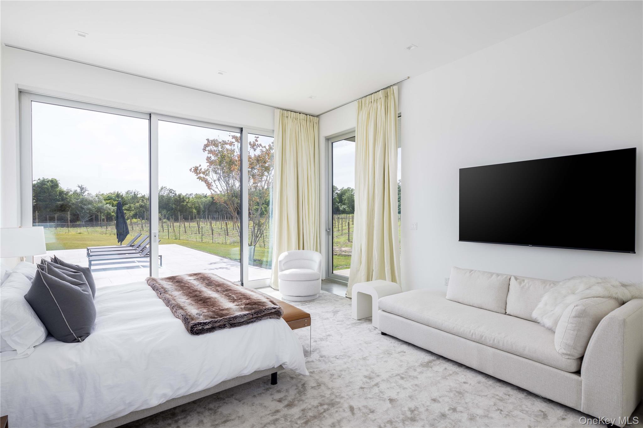 15105 Oregon Road Cutchogue, NY 11935 - Photo 18 of 24 a living room with furniture and a flat screen tv