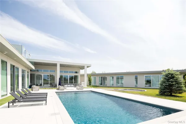 a view of a house with swimming pool and a yard