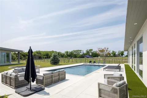 a view of swimming pool with seating area and furniture