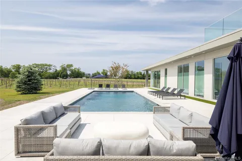 a view of swimming pool with seating area and furniture
