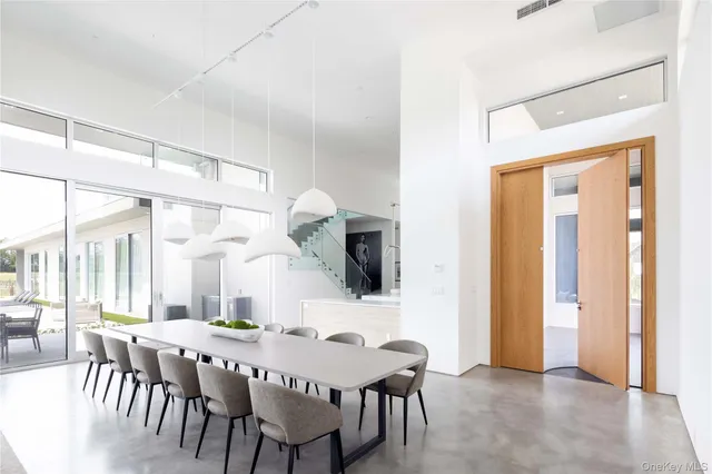 a view of a a dining room with furniture window and wooden floor