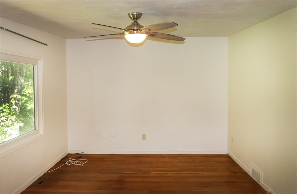 583 Gay Street, Unit A Westwood, MA 02090 - Photo 11 of 14 an empty room with wooden floor and windows