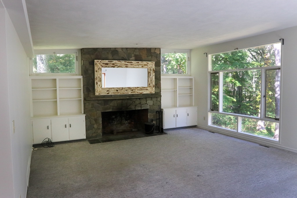 583 Gay Street, Unit A Westwood, MA 02090 - Photo 2 of 14 a living room with a fireplace and a flat screen tv