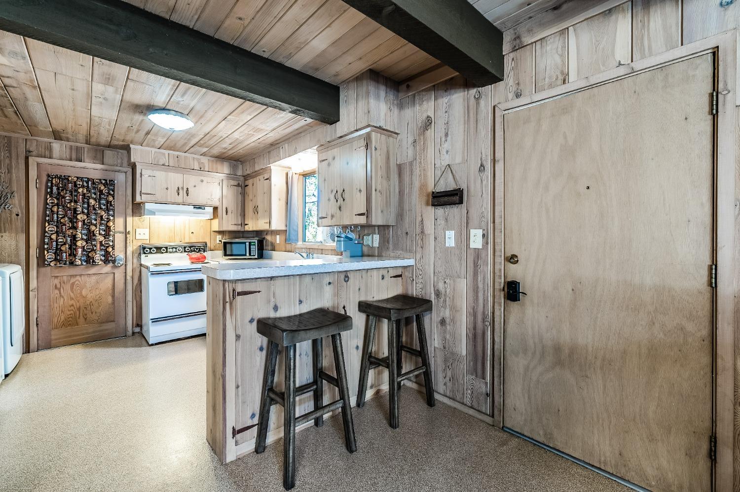 41277 Timber Drive Shaver Lake, CA 93664 - Photo 13 of 24 a kitchen with stainless steel appliances granite countertop a refrigerator and a stove