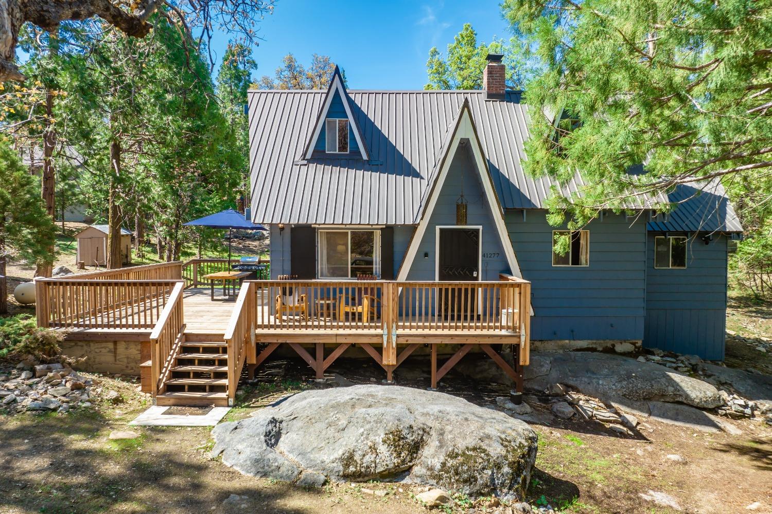 41277 Timber Drive Shaver Lake, CA 93664 - Photo 2 of 24 a view of a house with a wooden door and chair