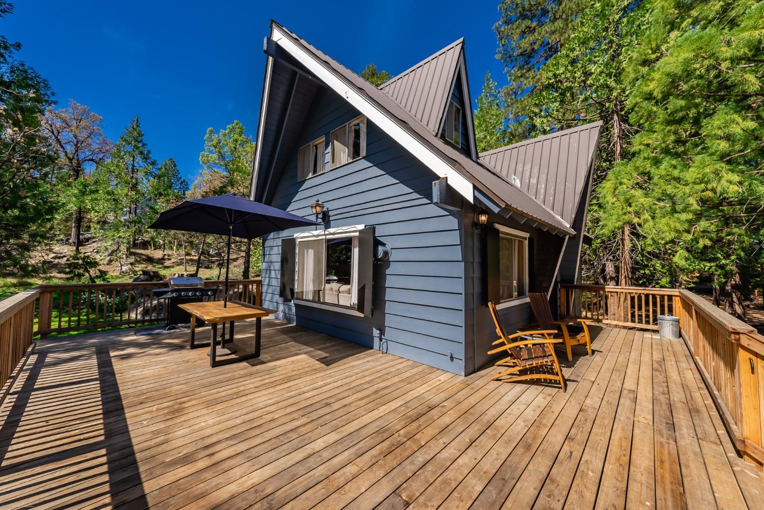 41277 Timber Drive Shaver Lake, CA 93664 - Photo 7 of 24 a balcony with wooden floor table and chairs