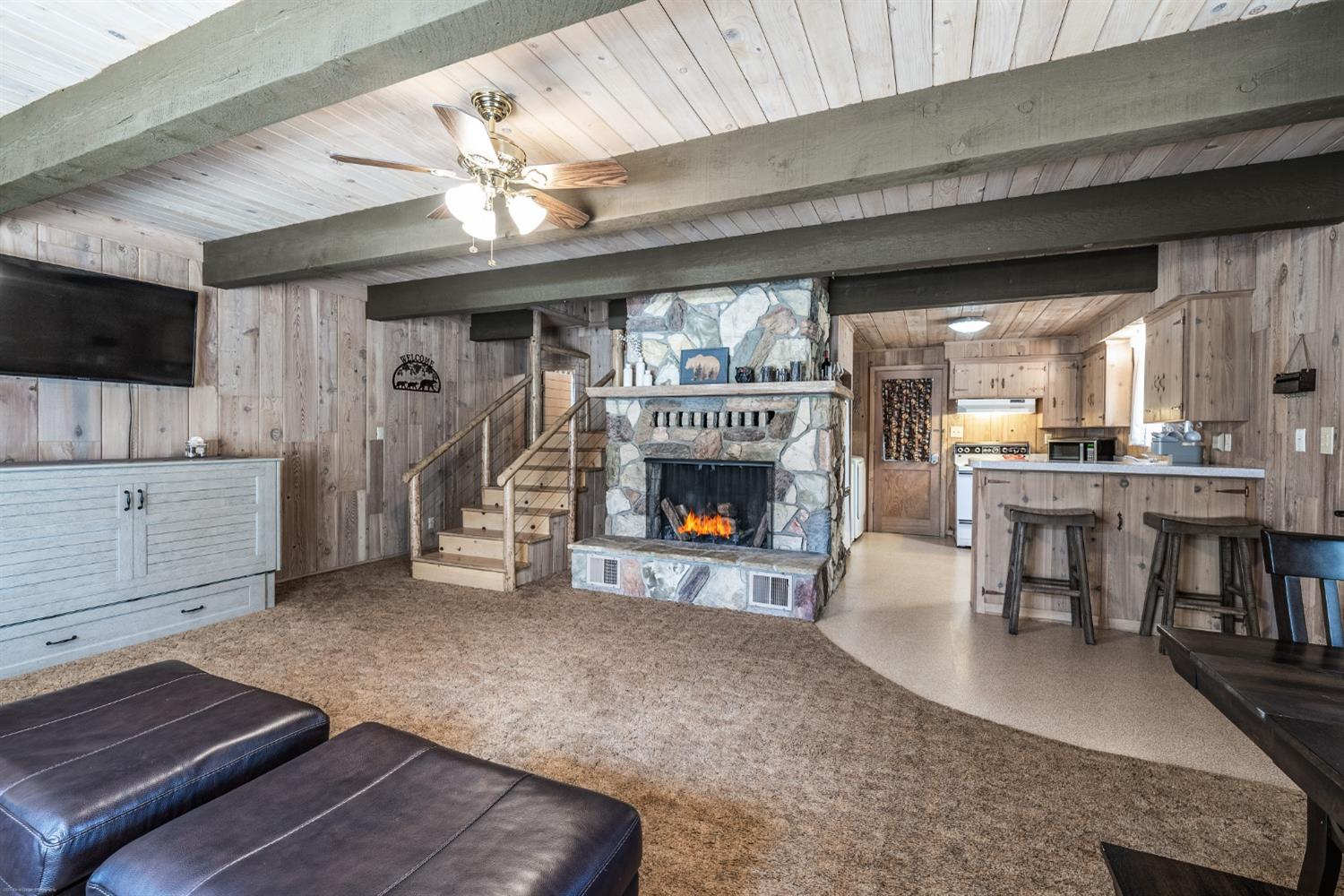 41277 Timber Drive Shaver Lake, CA 93664 - Photo 10 of 24 a living room with furniture a fireplace and a flat screen tv